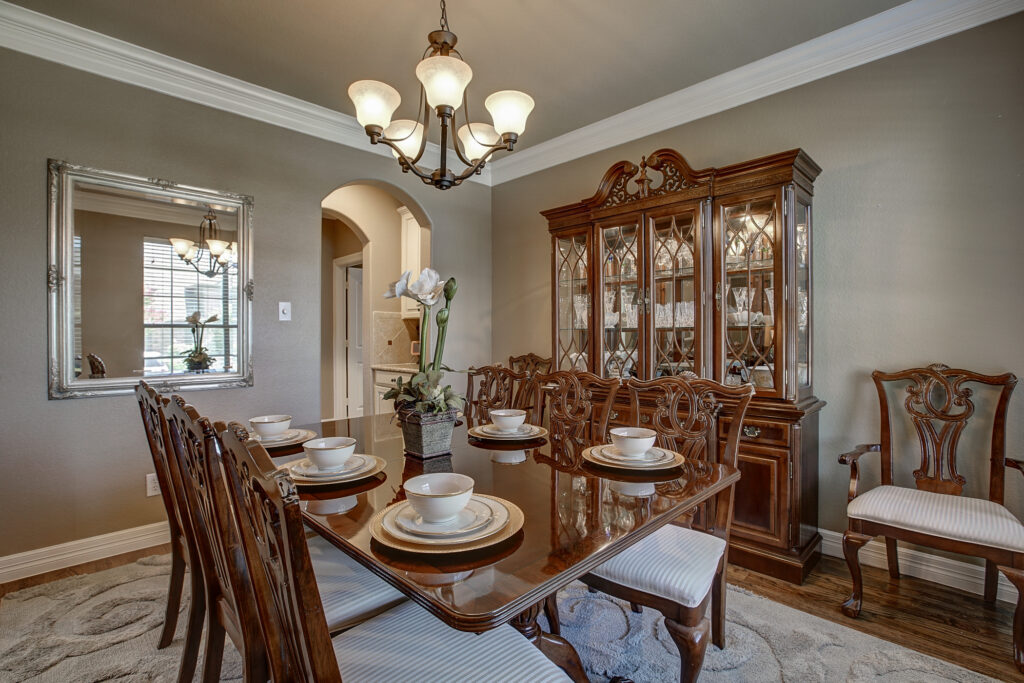Dining room with table setting, chandelier, and china cabinet