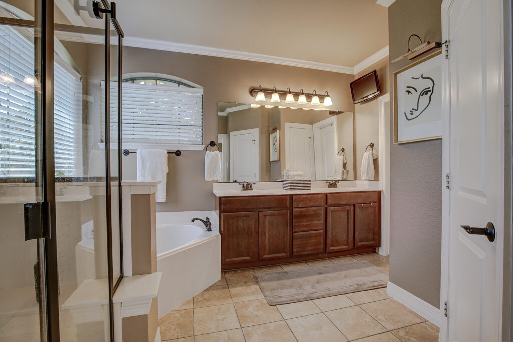 Double vanity bathroom with framed mirror and overhead lighting
