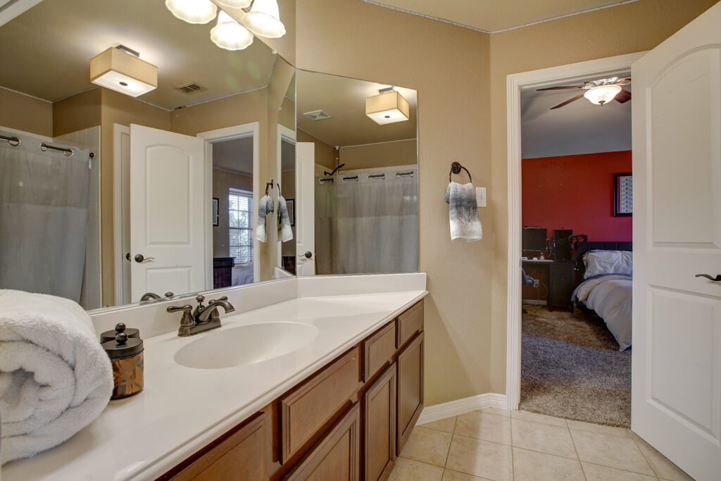 Jack and Jill bathroom with long countertop and two entryways