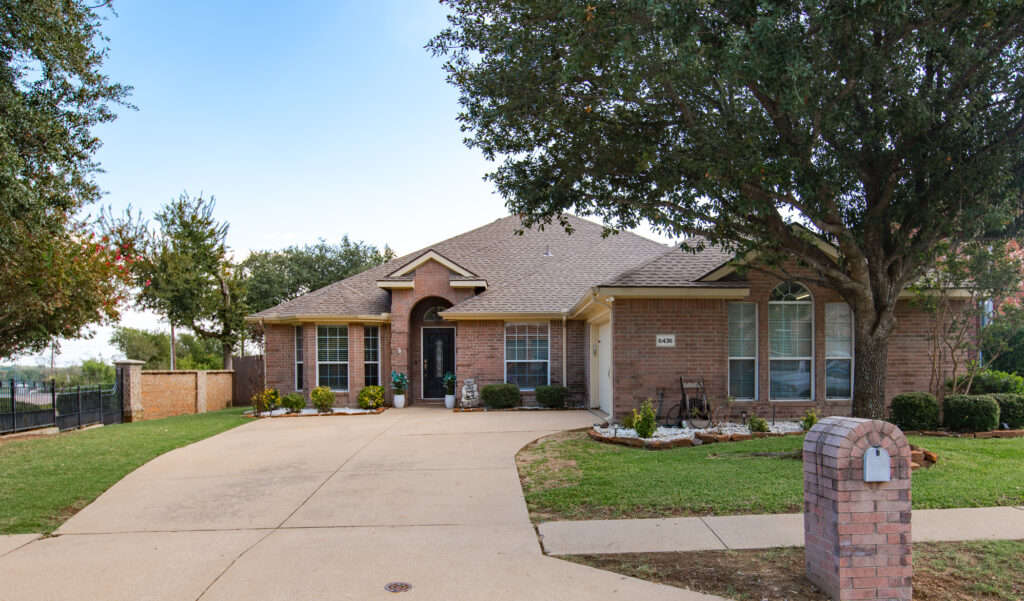 Front view of home with brick mailbox and large tree in yard at 6436 Meadowcrest Lane