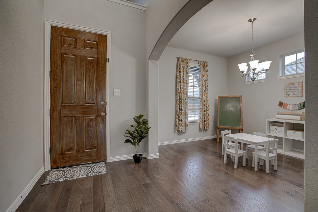 Entryway view with natural light and dining/playroom setup in Wylie home