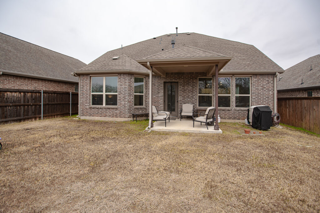 Covered patio and full brick exterior of Wylie home