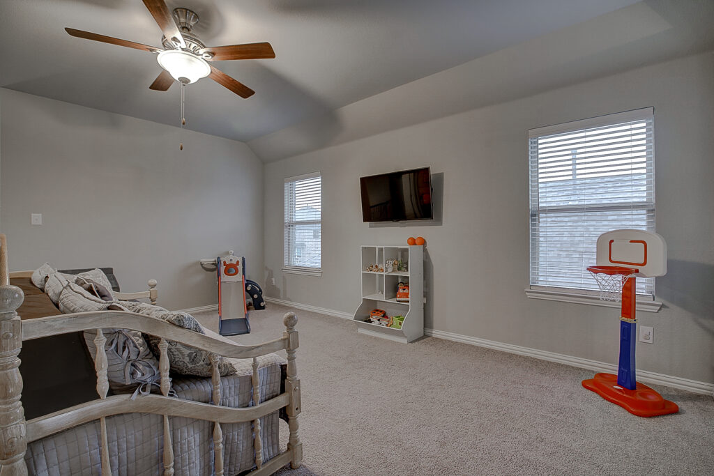 Game room with daybed, mini basketball hoop, and large windows