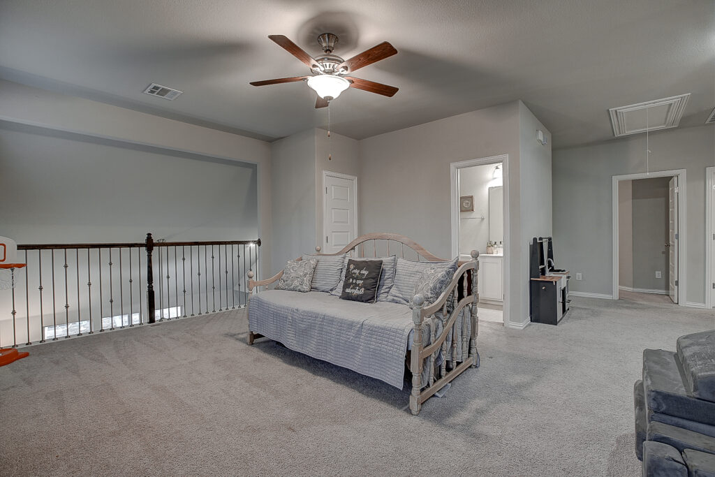 Upstairs game room showcasing railing and full layout view