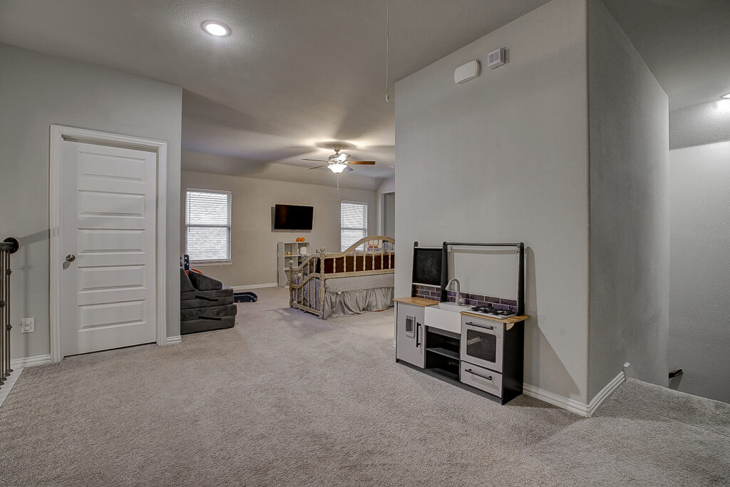 Game room entry view with kids play kitchen and ample floor space