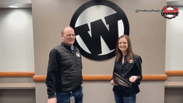 Kerri Jo Thain of FireBoss Realty and Scott Winn of Wylie ISD standing together while discussing Wylie ISD’s open enrollment program.