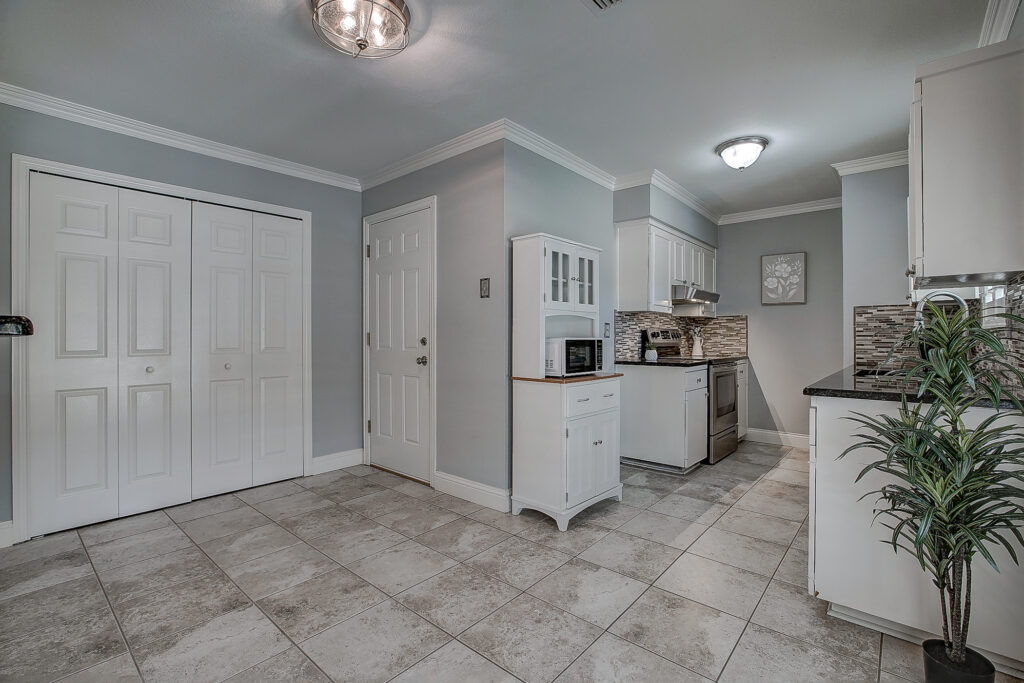 Kitchen at 5302 Saddleback Rd Garland TX with tile flooring, white cabinets, and stainless steel appliances