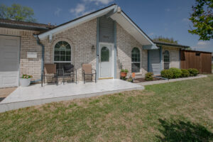 Front patio and entry at 5302 Saddleback Rd Garland TX with porch, seating area, and brick exterior