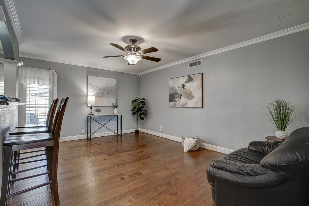 Main living area at 5302 Saddleback Rd Garland TX with wood flooring, bar seating, and open concept layout