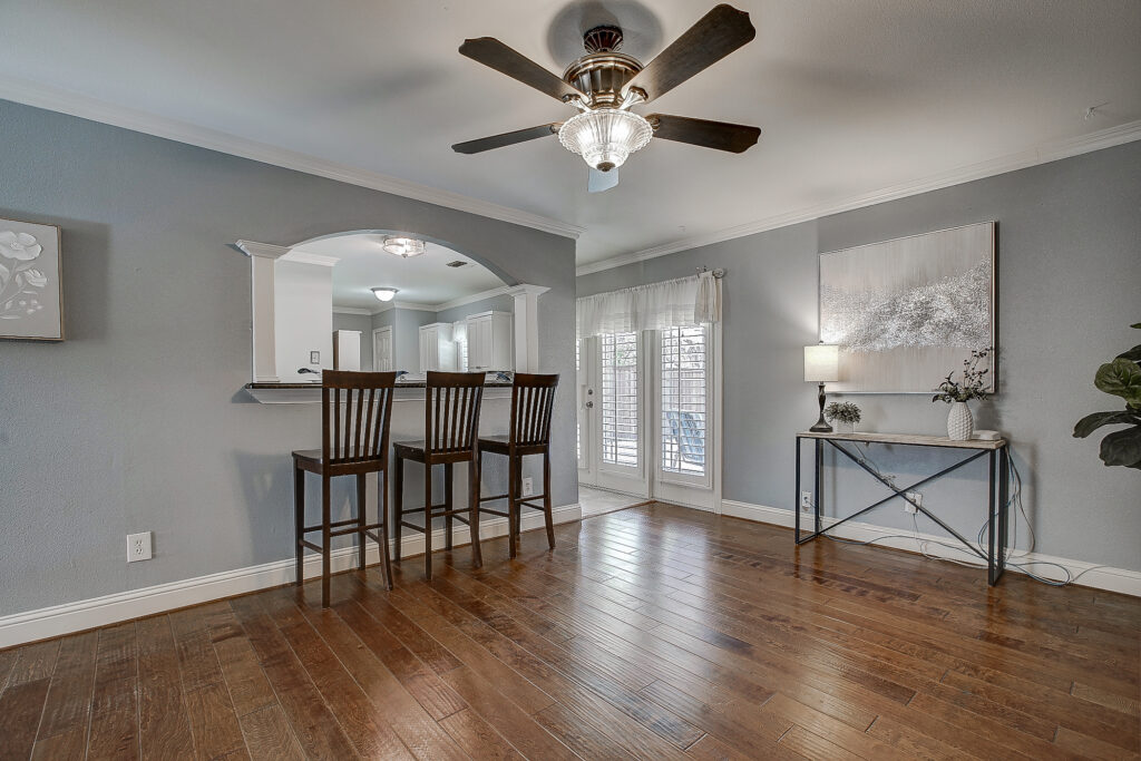 Main living area at 5302 Saddleback Rd Garland TX with wood floors, natural light, and open floor plan