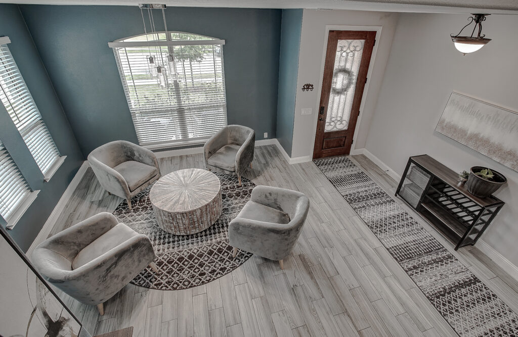 Overhead view of formal living room with modern seating area, wood-look tile flooring, and natural light